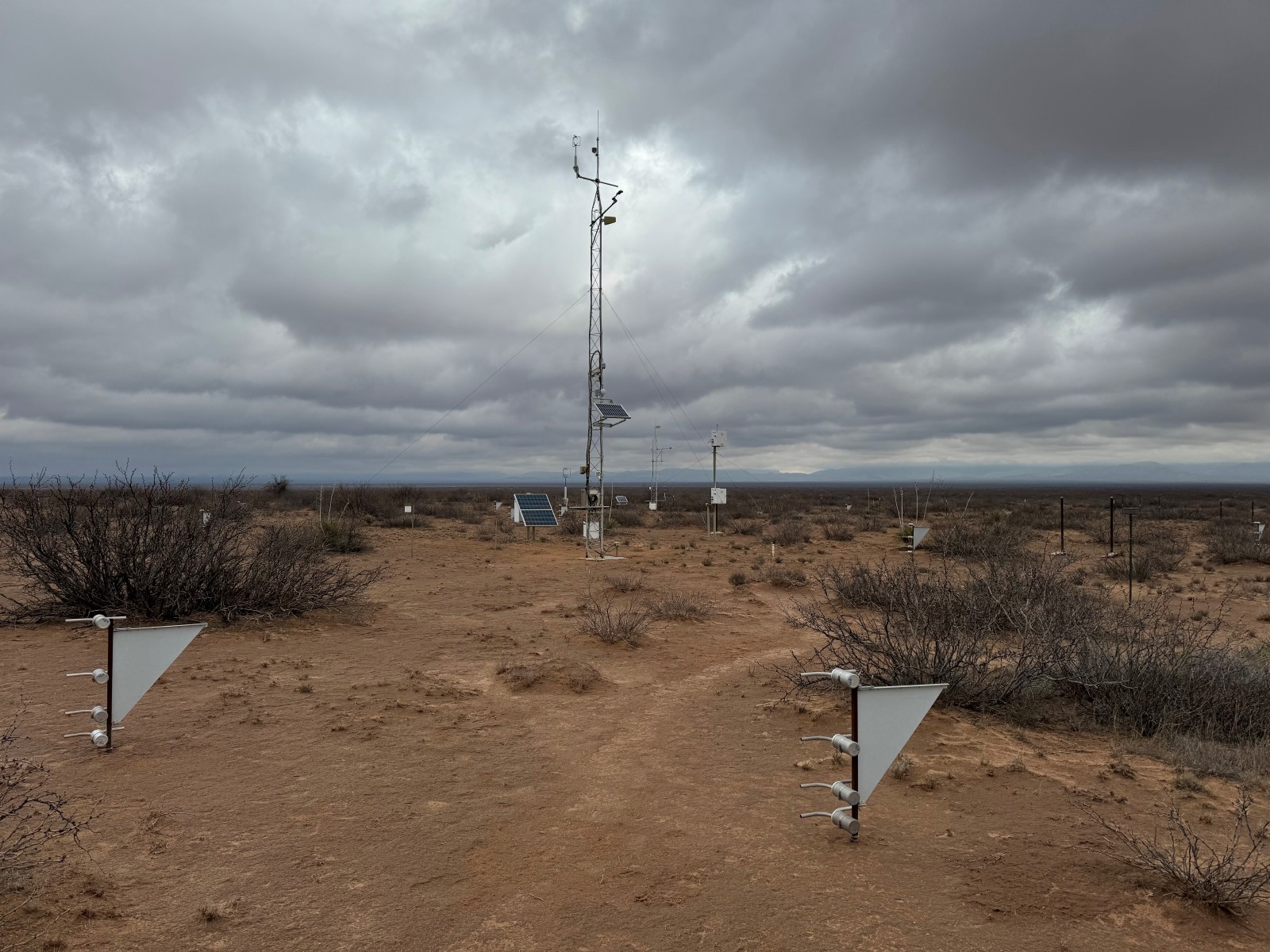 Photo of the Jornada Experimental Range (LTAR) Network site showing meteorological tower MWAC sediment samplers, and rain gauge.