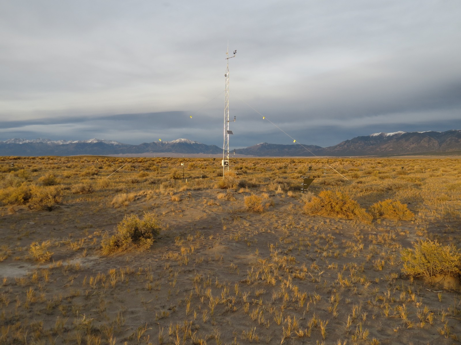 Photo of the San Luis Valley (BLM) Network site with the Great Sand Dunes in the background at the foot of the Sangre de Cristo Mountains.